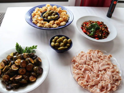 Italian catering buffet with mortadella, olives and red peppers