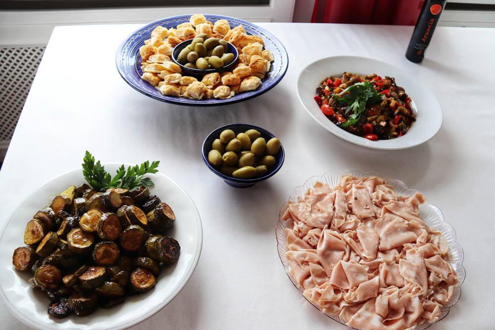 Italian catering buffet with mortadella, olives and red peppers